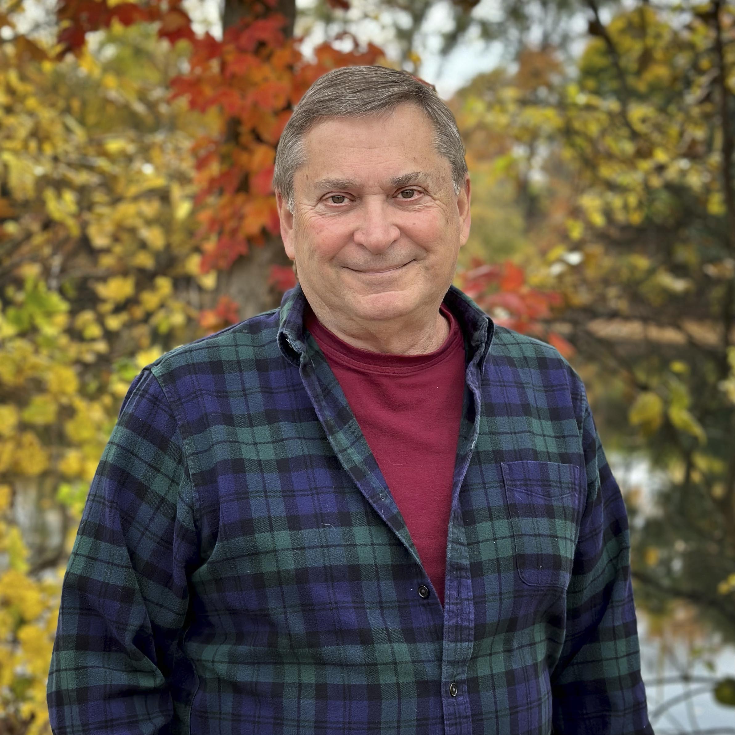 David Morgan in front of fall trees.